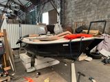 a man that is laying on a boat in a building