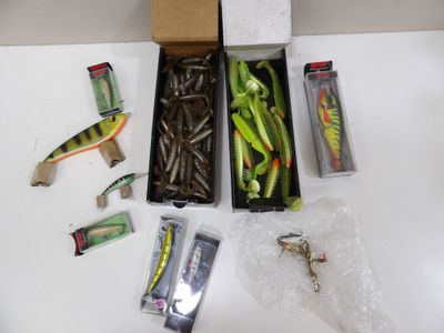 a box of assorted fishing lures on a table