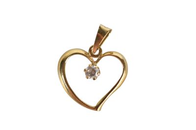 a gold heart shaped pendant with a diamond in the center