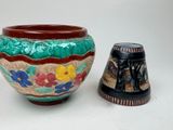 two vases sitting next to each other on a table