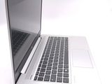 a laptop computer that is sitting on a white surface
