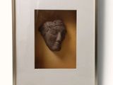 an image of a picture of a face in a shadow box