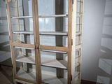 a tall cabinet with glass doors in a room