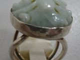 a picture of a ring with a green stone in it