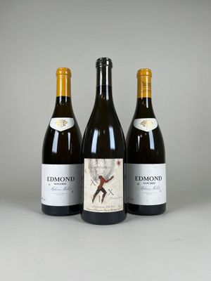 three bottles of wine sitting next to each other on a table