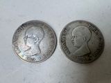 two silver coins with a profile of a man and a profile of a woman