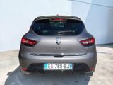 the rear end of a grey car parked in a parking lot
