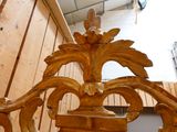 a close up of a wooden bench with a bird on it