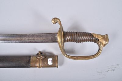 a sword that is laying on a table next to another sword