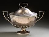 an antique silver plated bowl with a lid and handles