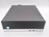 the hp desktop computer is sitting on a white surface