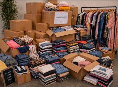 a large pile of clothes and boxes in a room