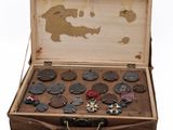 an old suitcase with a bunch of buttons in it