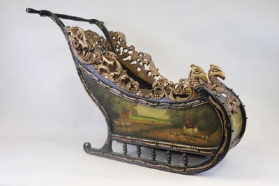 a metal sleigh with a painting on it