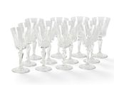 a lot of wine glasses that are lined up together