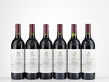 six bottles of red wine lined up in a row