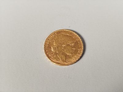 a close up of a gold coin on a white surface