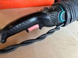 an image of a corded electric tool on a table