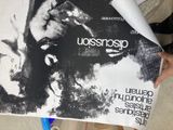 a person holding a poster with a picture of a man on it
