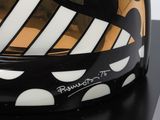 black, white and gold painted helmet on a black stand