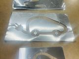 three pieces of metal on a table with a picture of a car on it