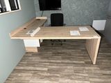 a wooden desk with a computer monitor on top of it
