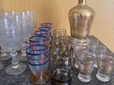 many glasses and a vase on the table