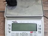 a digital scale with a mouse on top of it