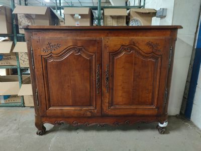 an old wooden cabinet in a warehouse with boxes in the background
