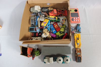 a cardboard box filled with assorted toy cars