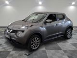 the silver nissan juke is parked on a checkered tile floor