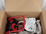 a cardboard box with a red handle and some items in it