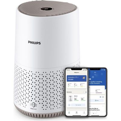 Le purificateur d'air intelligent Philips est placé à côté d'un iPhone et d'un smartphone
