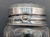 a glass jar with a diamond inside of it
