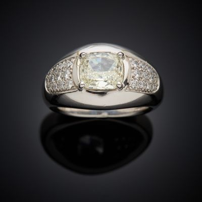 a close up of a ring with a diamond on a black surface