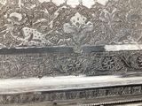 a silver box that has a flower design on it