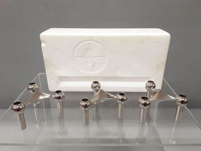an image of a set of six chrome and glass sink faucets on a clear surface