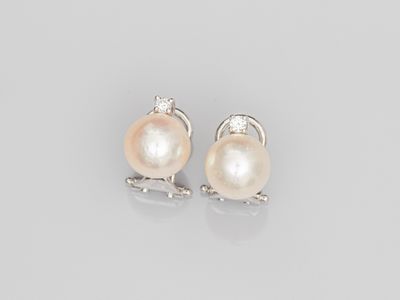 a pair of pearl and diamond earrings