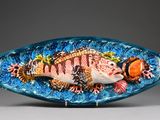 a glass fish that is sitting on top of a table