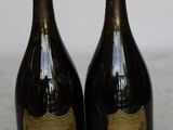 two bottles of champagne sitting on top of a marble counter top