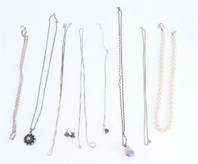 several different types of necklaces are arranged on a white surface