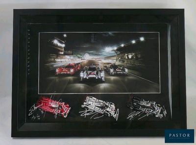 framed photograph of a race car with autographs signed by the drivers
