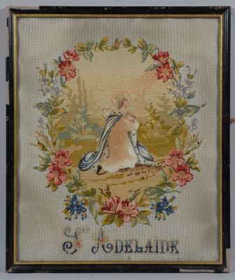 an antique needled picture of a woman in a dress with flowers