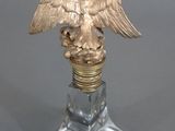 a statue of an eagle that is on top of a light bulb