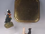 two figurines that are sitting next to a mirror