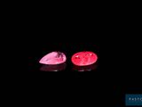 pair of pink tourmaline gems on a black background