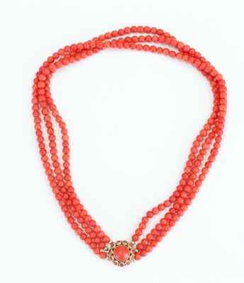 a coral beaded necklace with a gold clasp