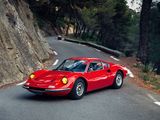 a red sports car driving down a winding road