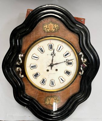a clock on the wall with roman numerals on it