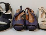 four pairs of women ' s shoes are lined up in a row